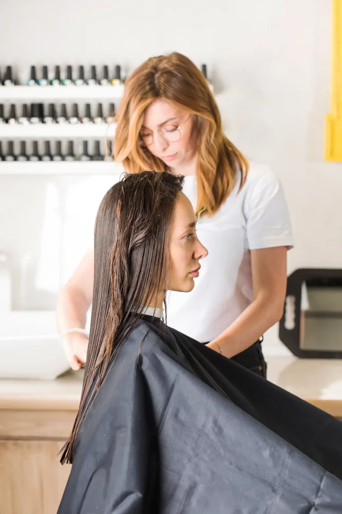 Hairdresser makes haircut client beauty salon