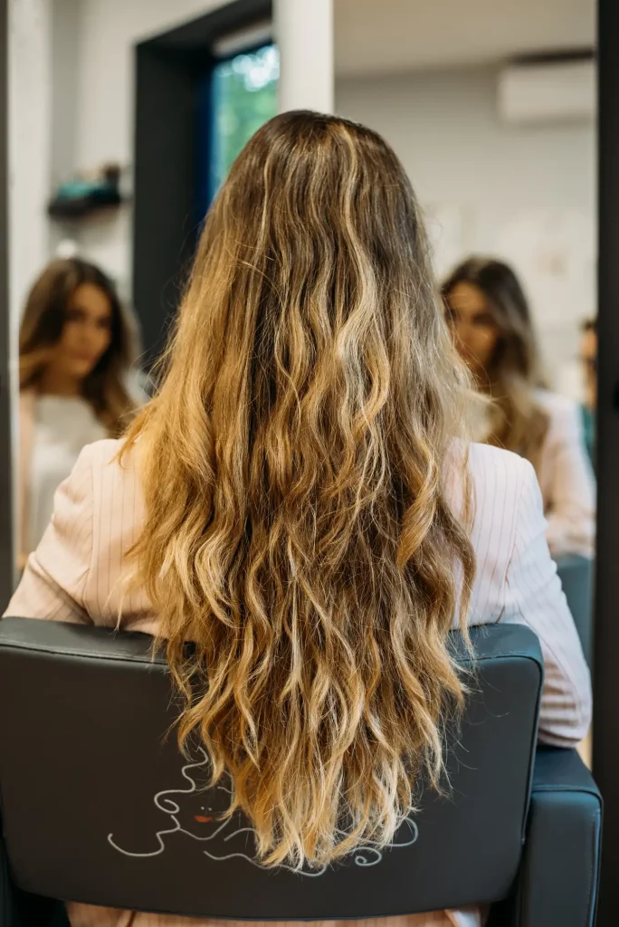 Woman with long hair sitting hairdresser